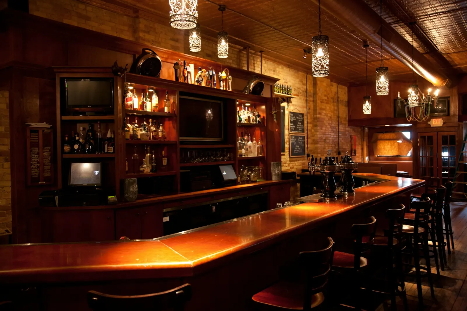The wooden bar counter and back bar in warm light
